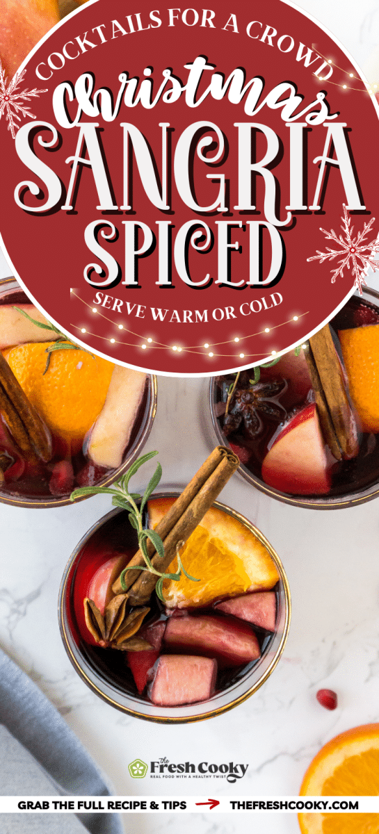 Spiced winter sangria in three glasses filled with fresh fruit and rosemary and cinnamon.