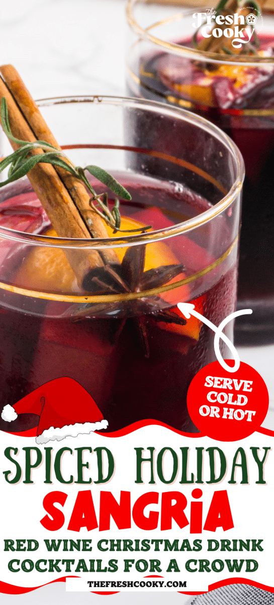 Spiced holiday sangria in a glass filled with fresh fruit, cinnamon stick and fresh rosemary, for pinning.