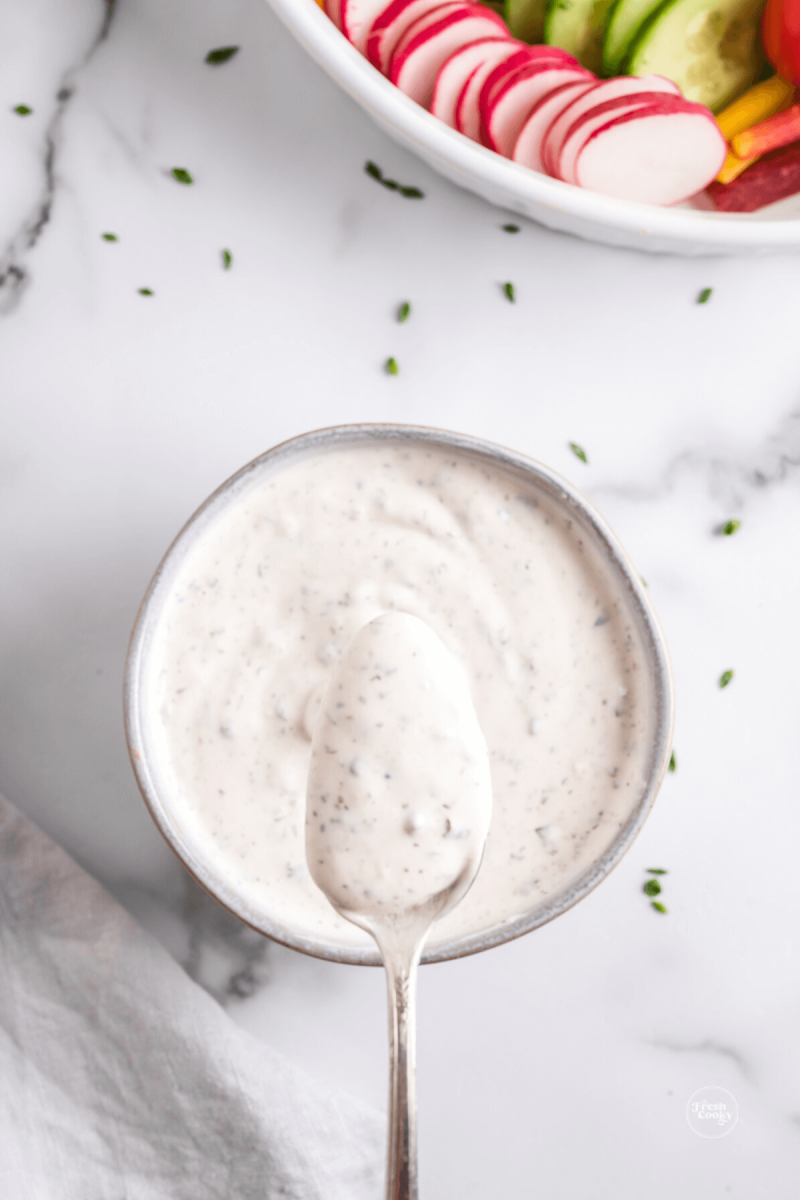 Best veggie dip in a gray bowl with spoon in it.