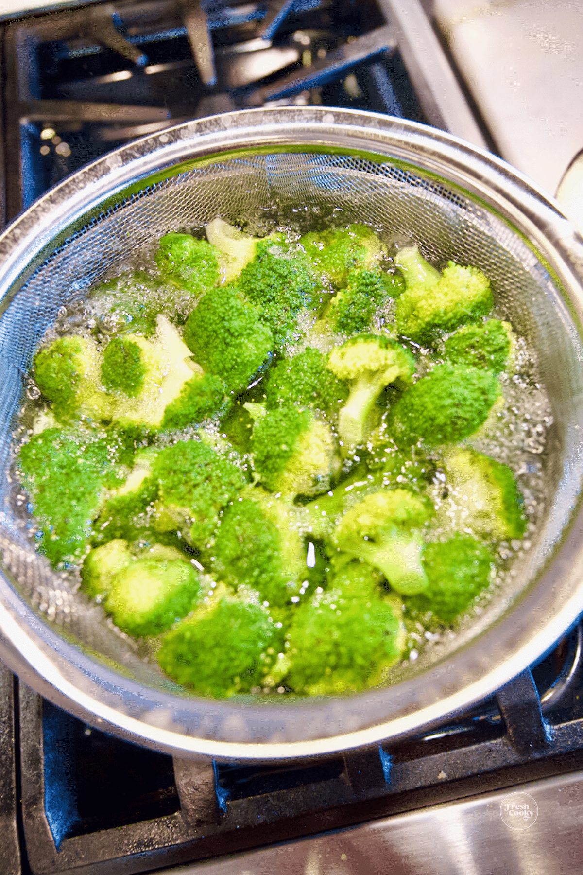 Broccoli in pot with boiling water, for blanching. 