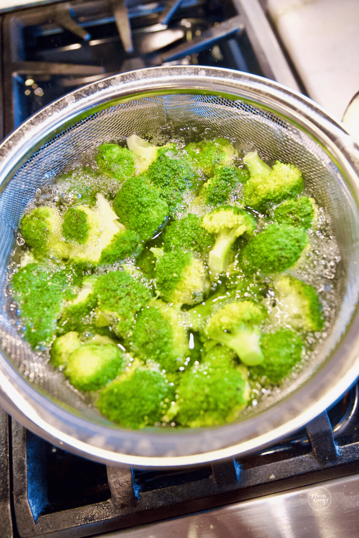 Broccoli in pot with boiling water, for blanching.