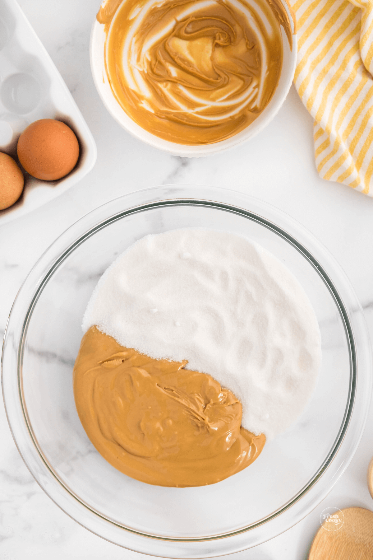 Peanut butter and sugar in mixing bowl. 