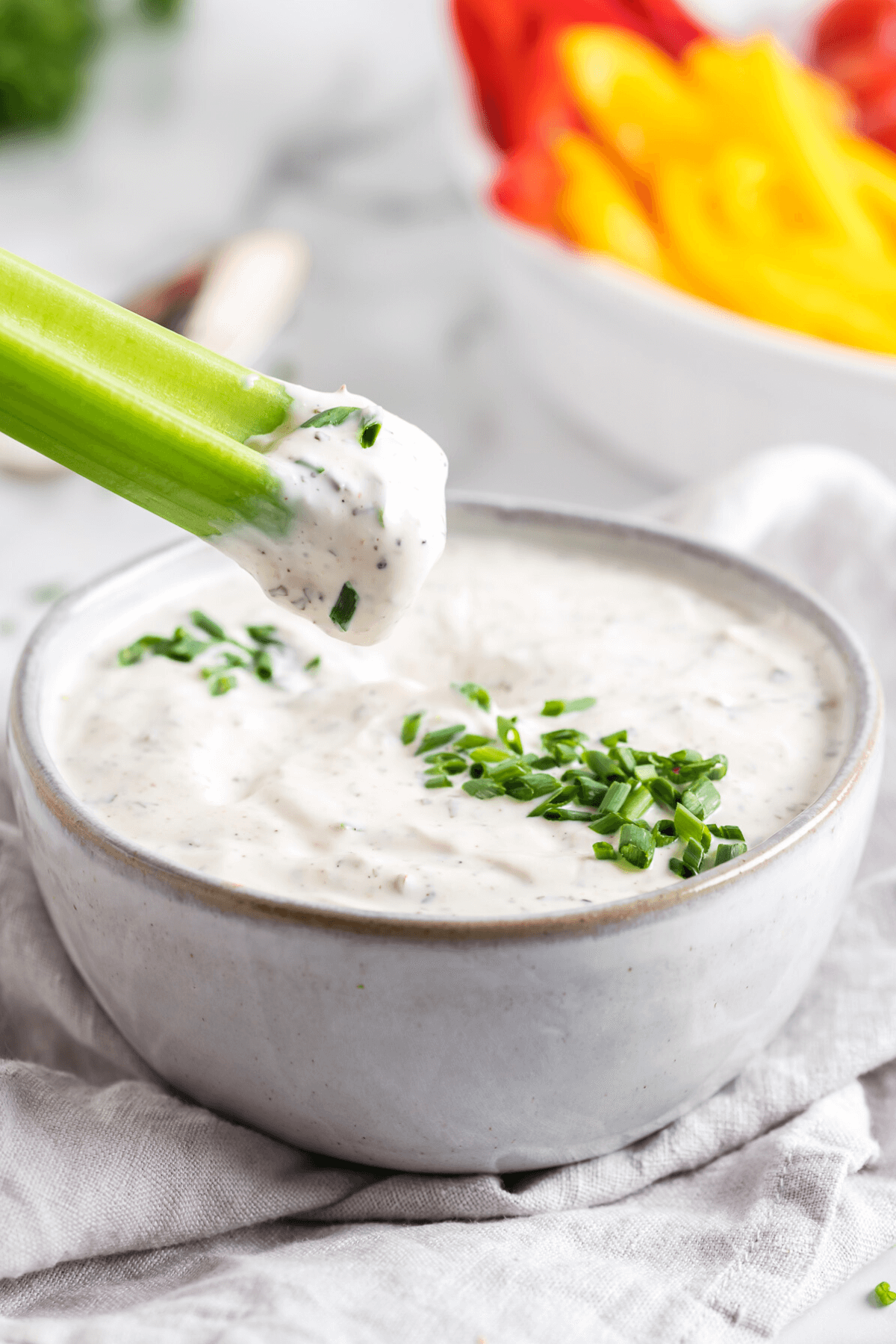 Dipping a celery stick in the best veggie dip.