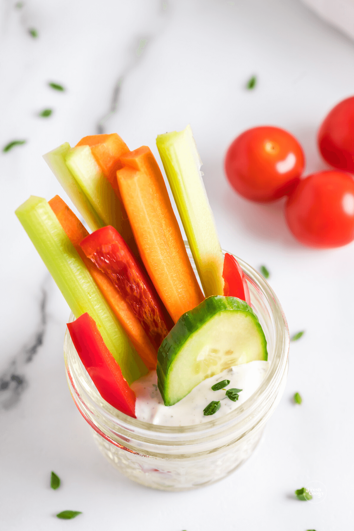 Crudite in a jar with dip for taking to go.