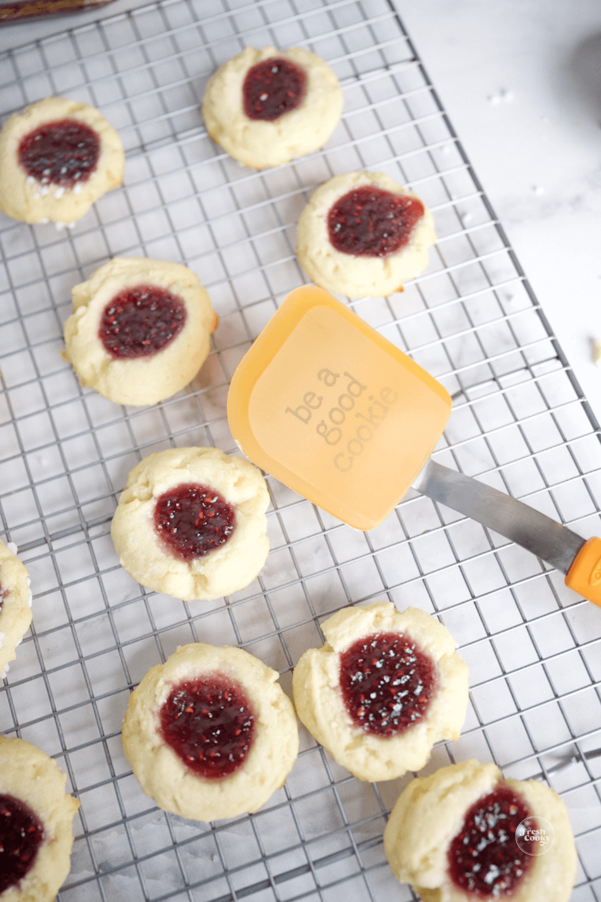 Using spatula to remove cookies onto cooling rack.