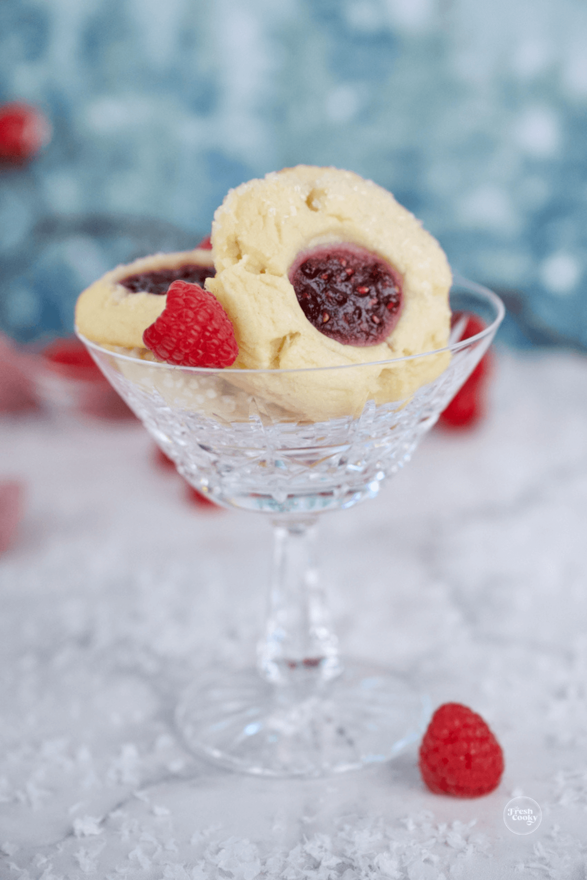 Raspberry thumbprint cookies in pretty glass.