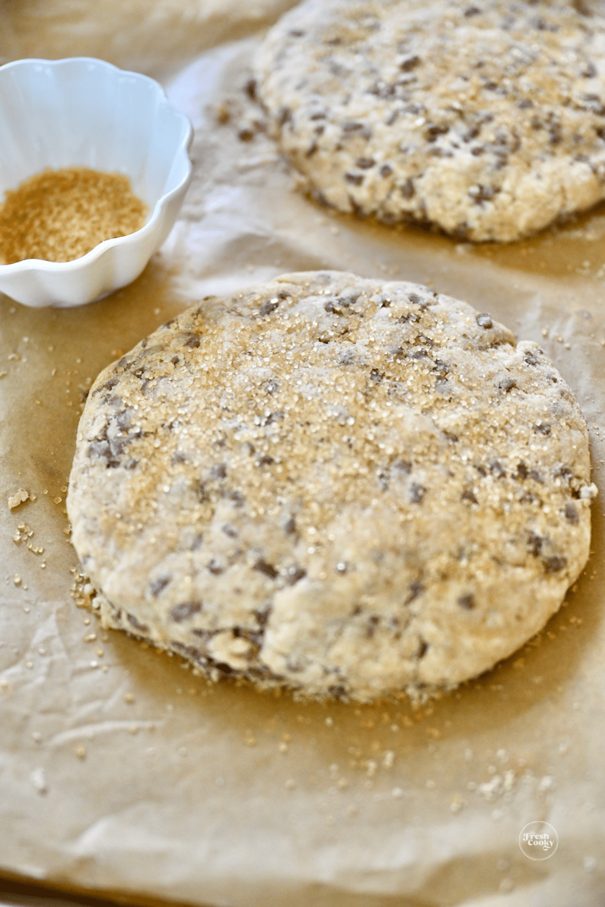 Cinnamon chip scone discs with demerara sugar sprinkled on top.