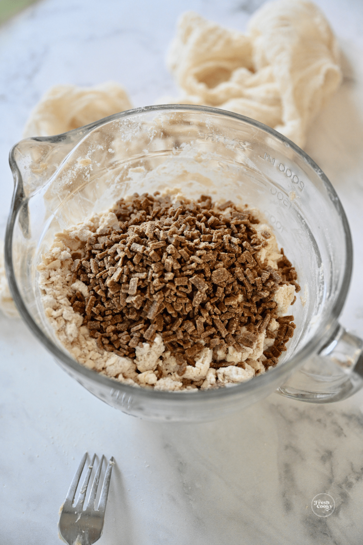 Adding cinnamon chips to scone dough. 