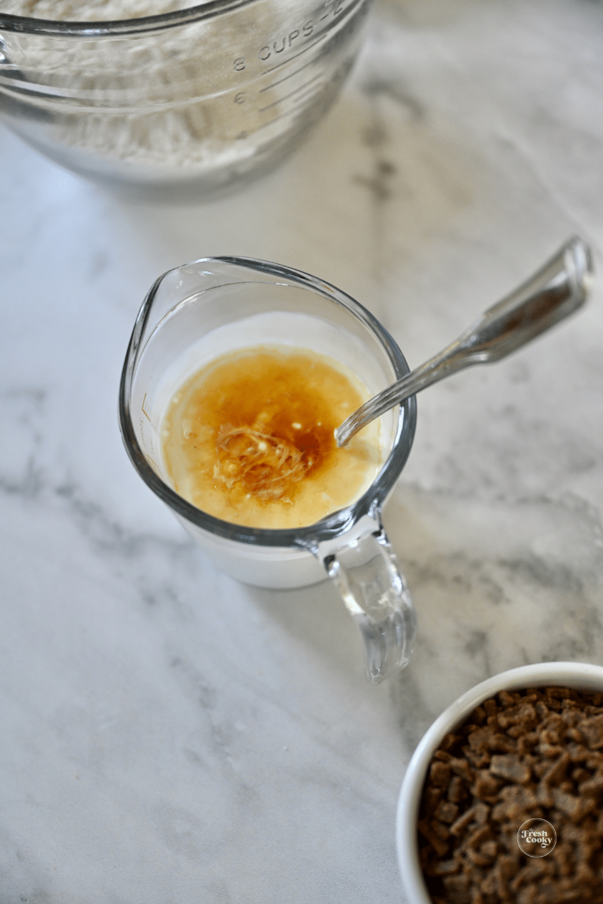 Stirring in vanilla extract to cream mixture.