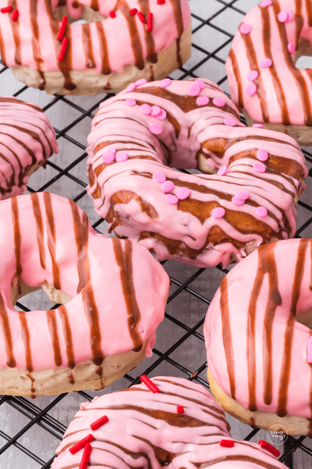Air fryer biscuit donuts on rack heart shaped.