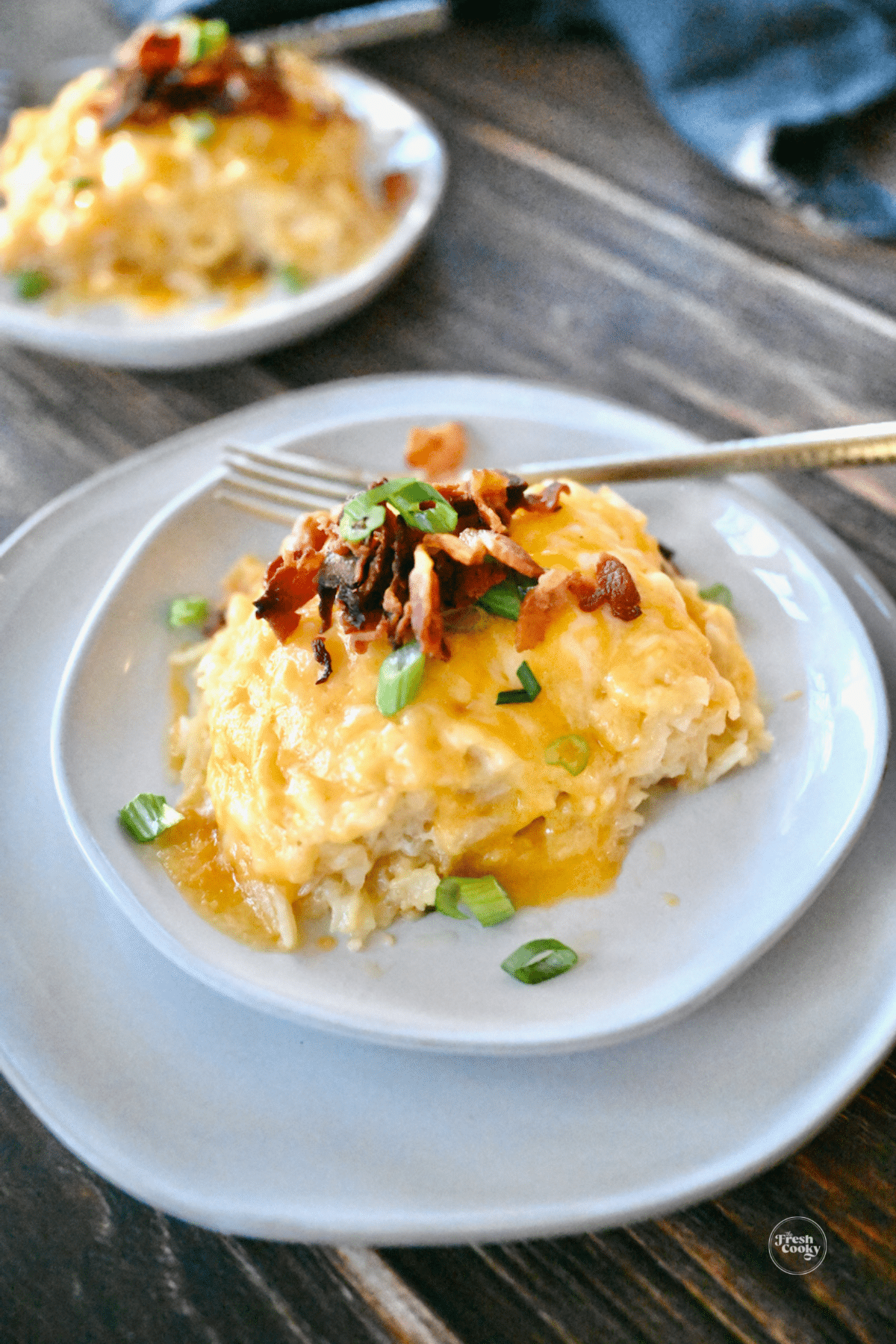 Loaded Cracker Barrel Hashbrown casserole topped with bacon and green onions.