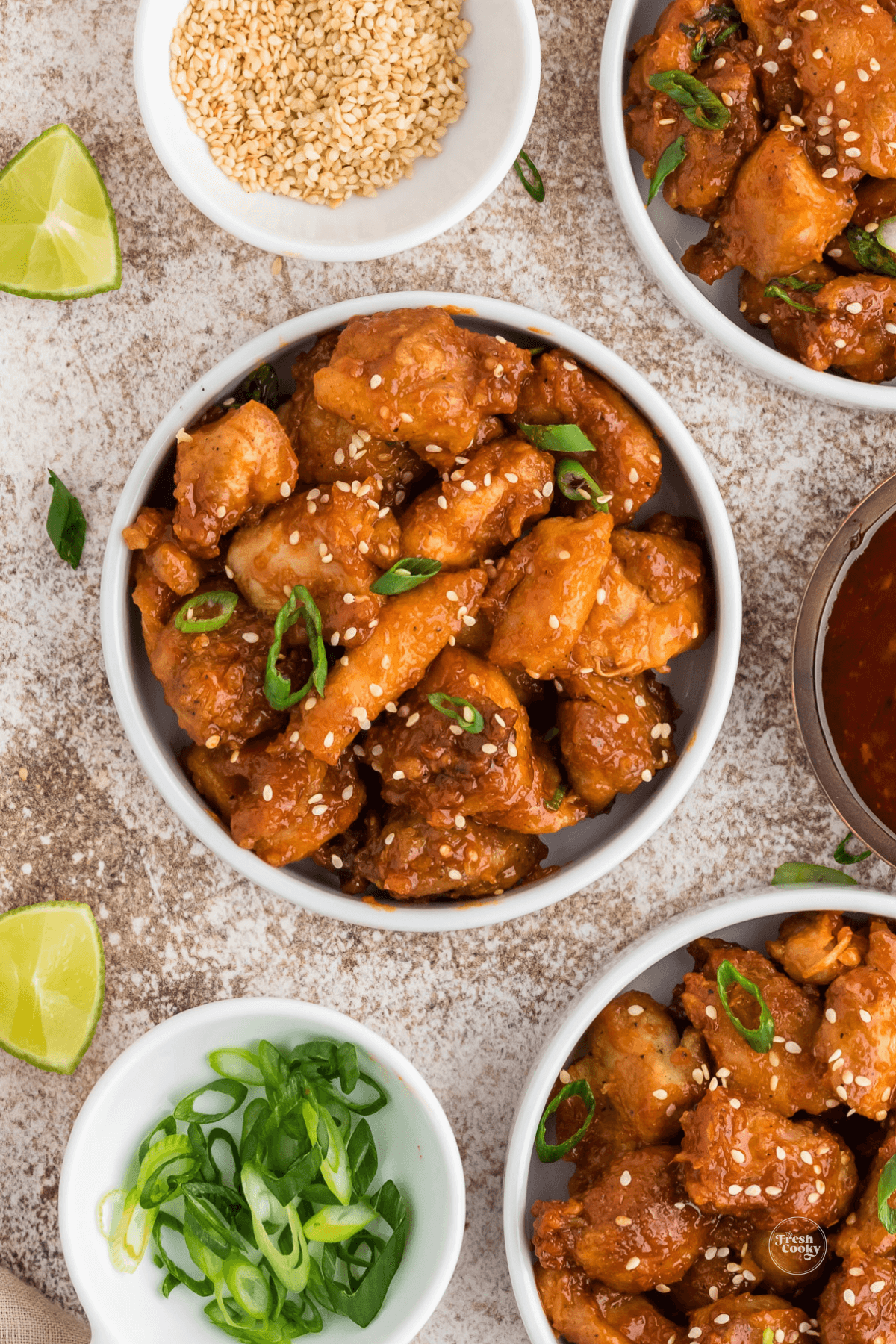 Korean chicken made in the air fryer, in tiny serving bowls.