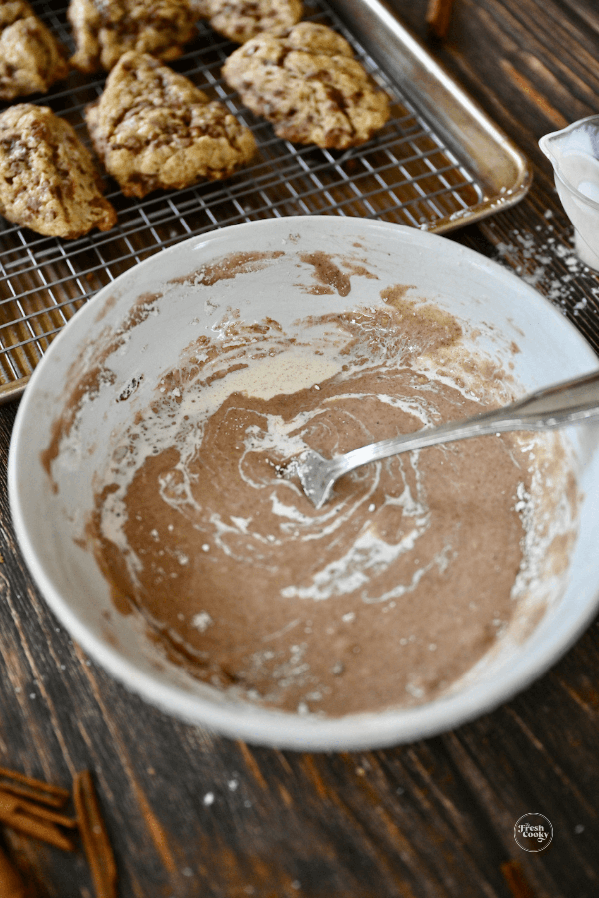 Mixing Cinnamon glaze in small bowl for drizzling on scones.