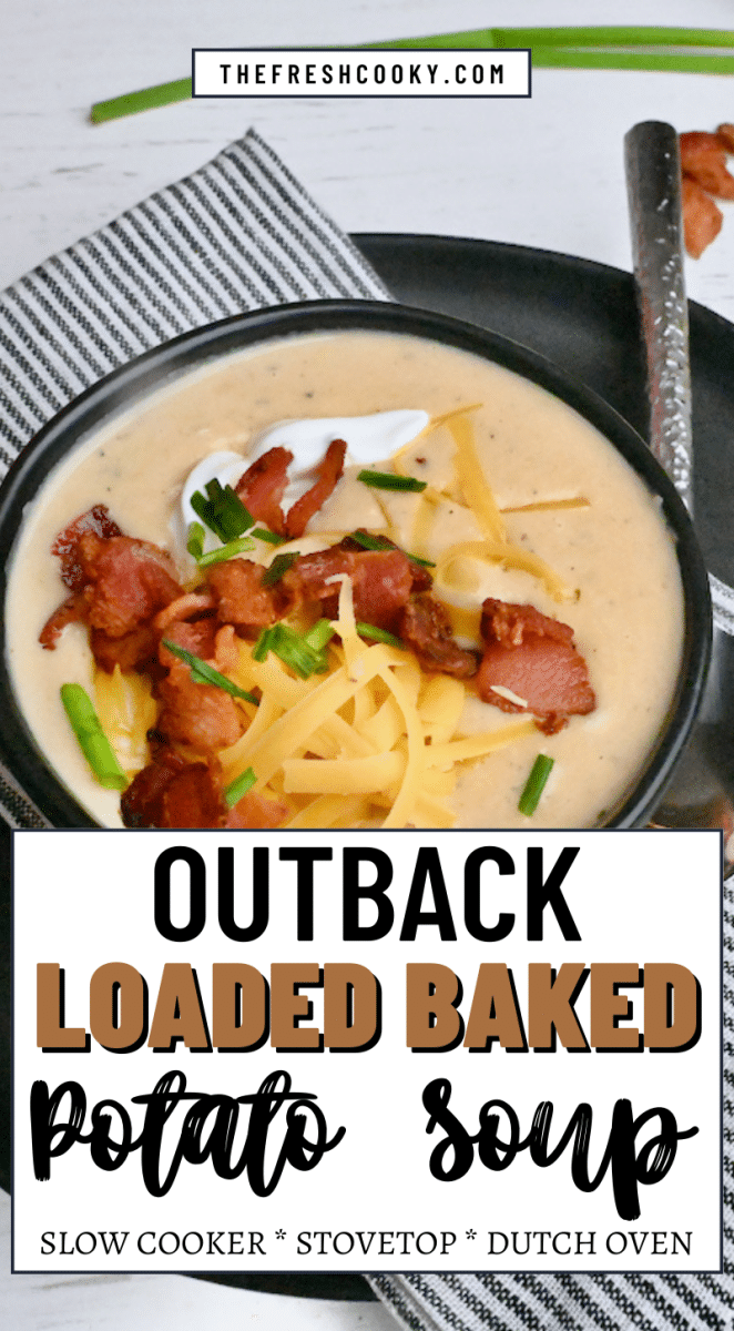 Outback Loaded Baked Potato Soup in a black bowl topped with crisp bacon, shredded cheddar, chives and sour cream, to pin.