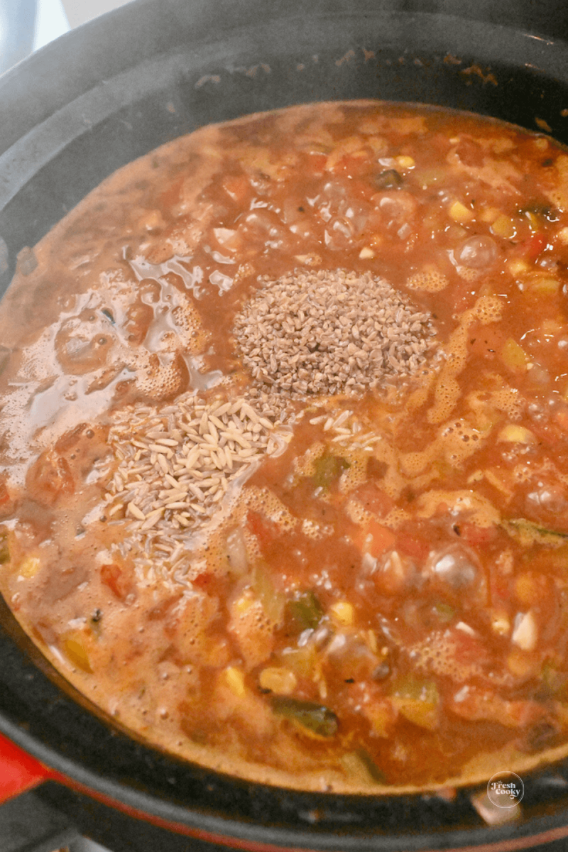Adding in sprouted brown rice and wheat berries into 10 vegetable soup.