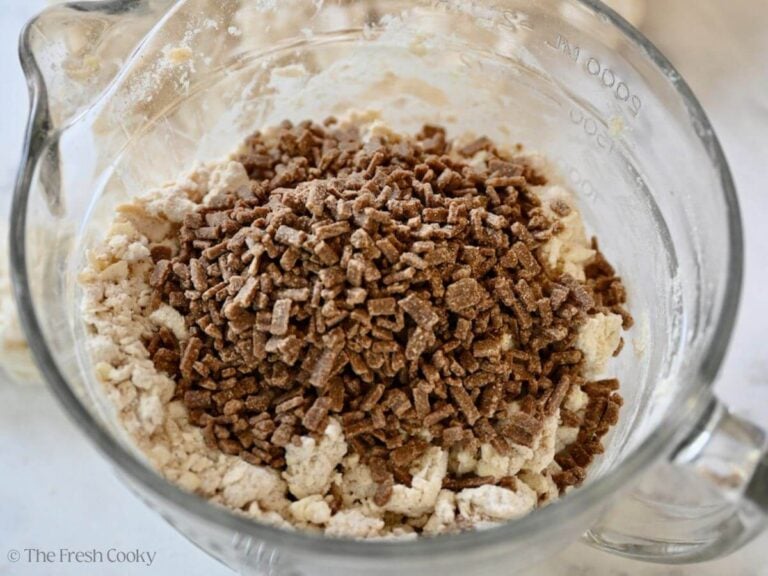Adding cinnamon chips to scone dough.