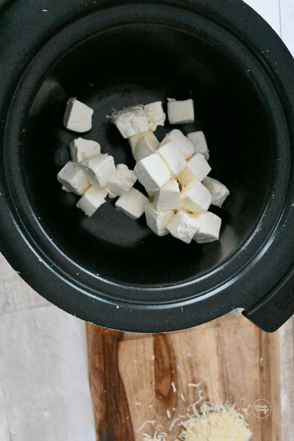 Cream cheese blocks in bottom of slow cooker.