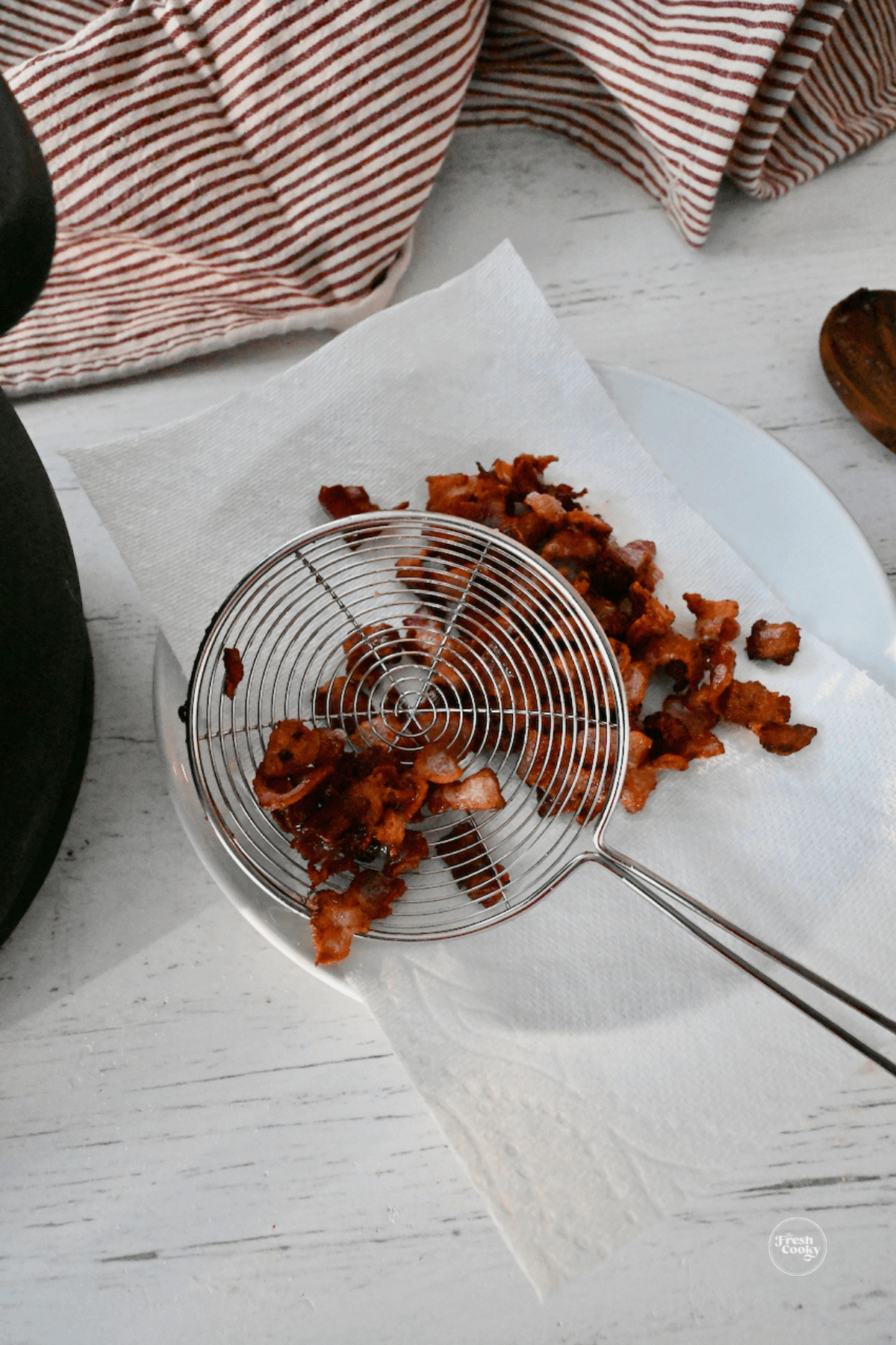 Draining bacon on paper towel lined plate. 