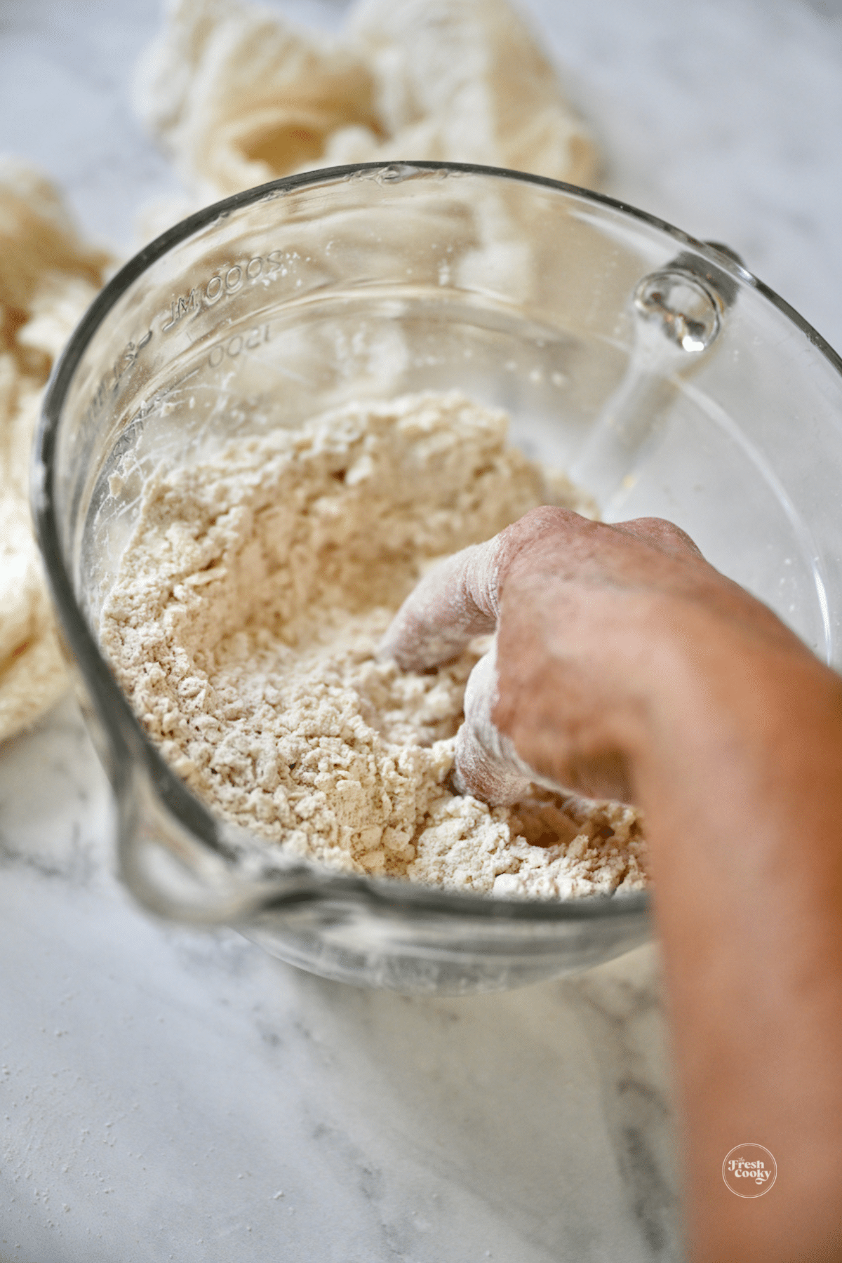 Hand mixing butter with dry scone ingredients.