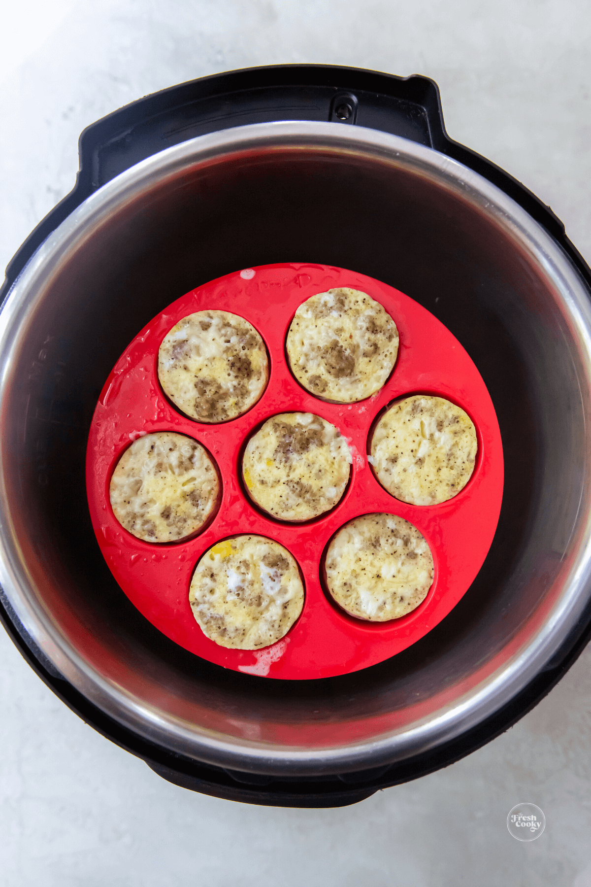 Finished cooking egg bites in silicone baking mold inside Instant Pot. 