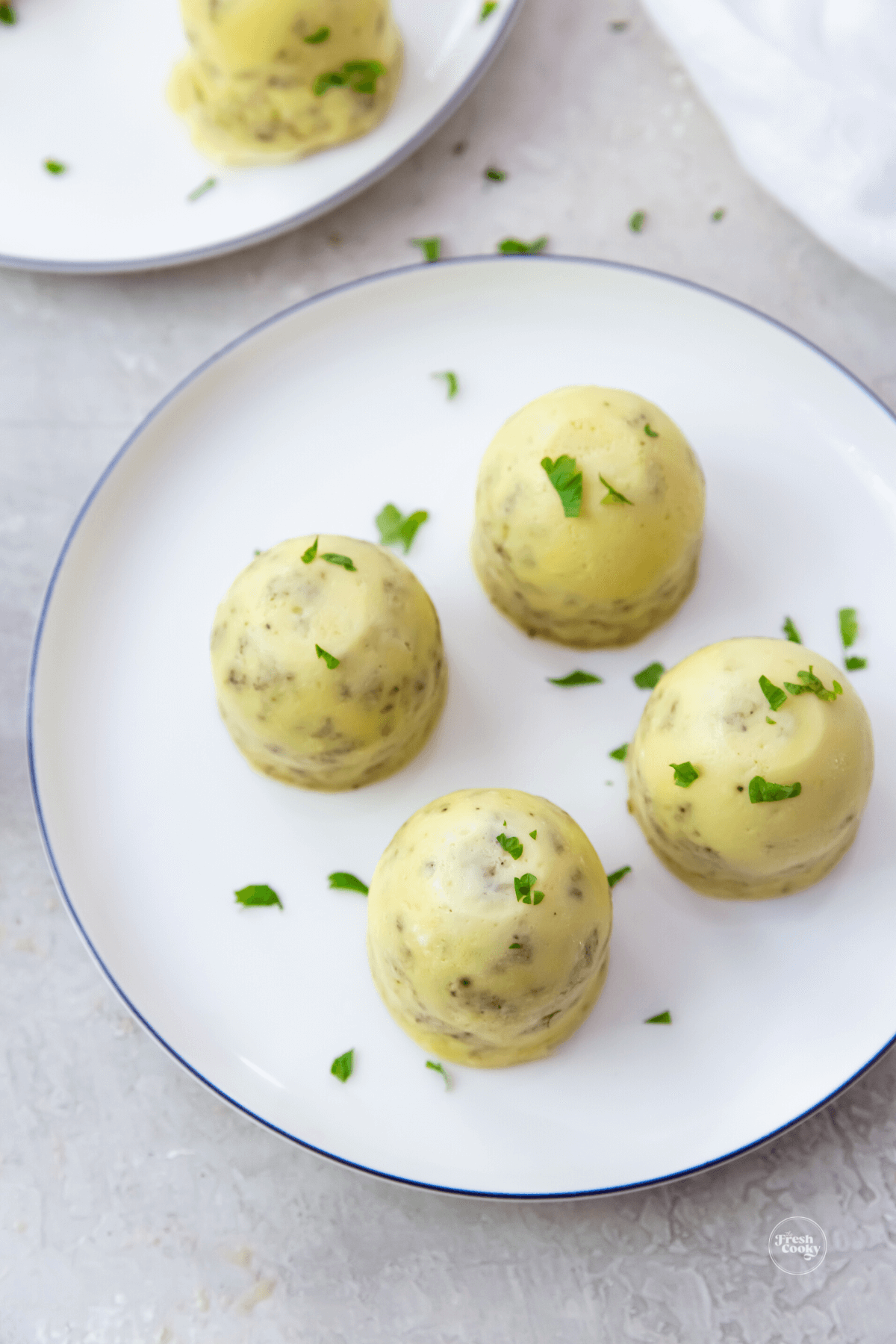 Egg nites on a plate sprinkled with a little fresh parsley. 