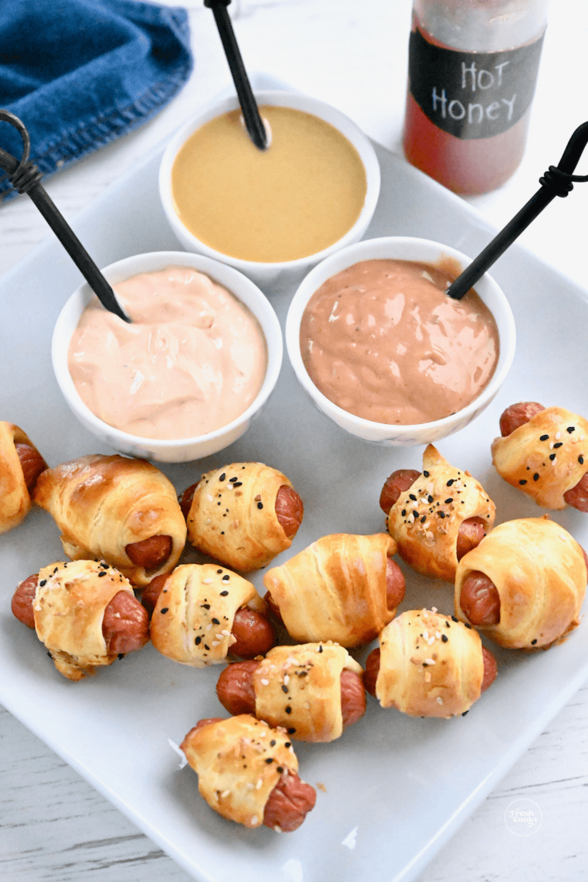 Pigs in a blanket with three dipping sauces.