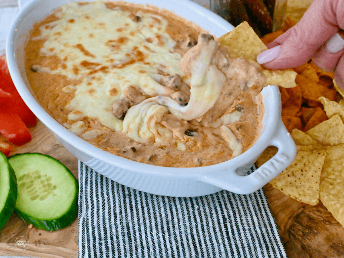 Chili cheese dip served with tortilla chips.