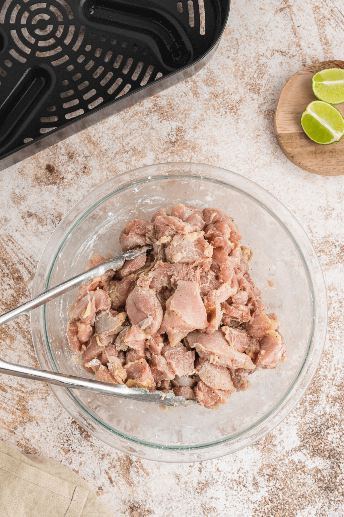 Chicken thigh pieces tossed in seasonings and cornstarch.