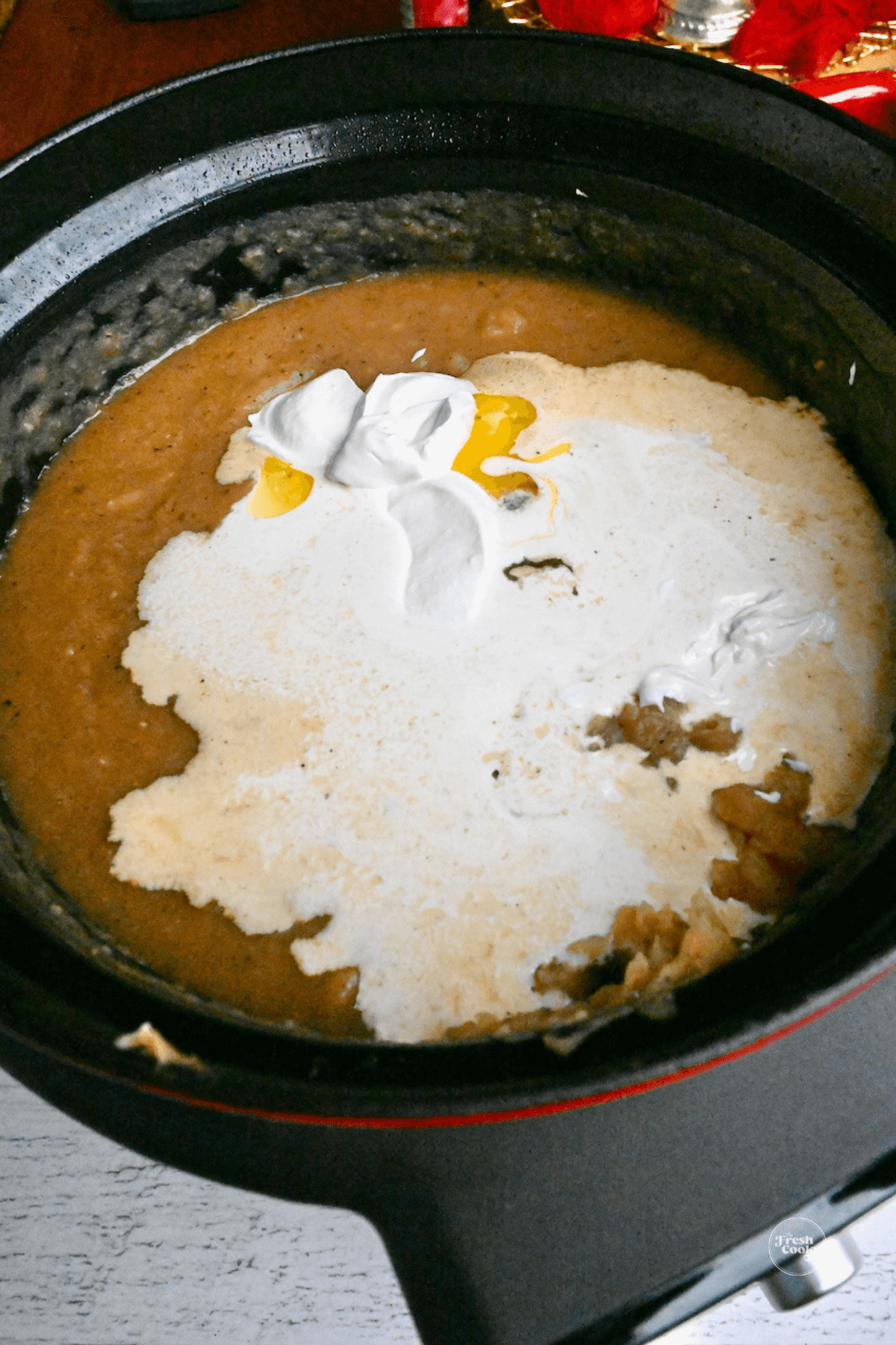 Sour cream added to potato soup. 