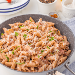 One pot creamy sausage pasta in skillet.