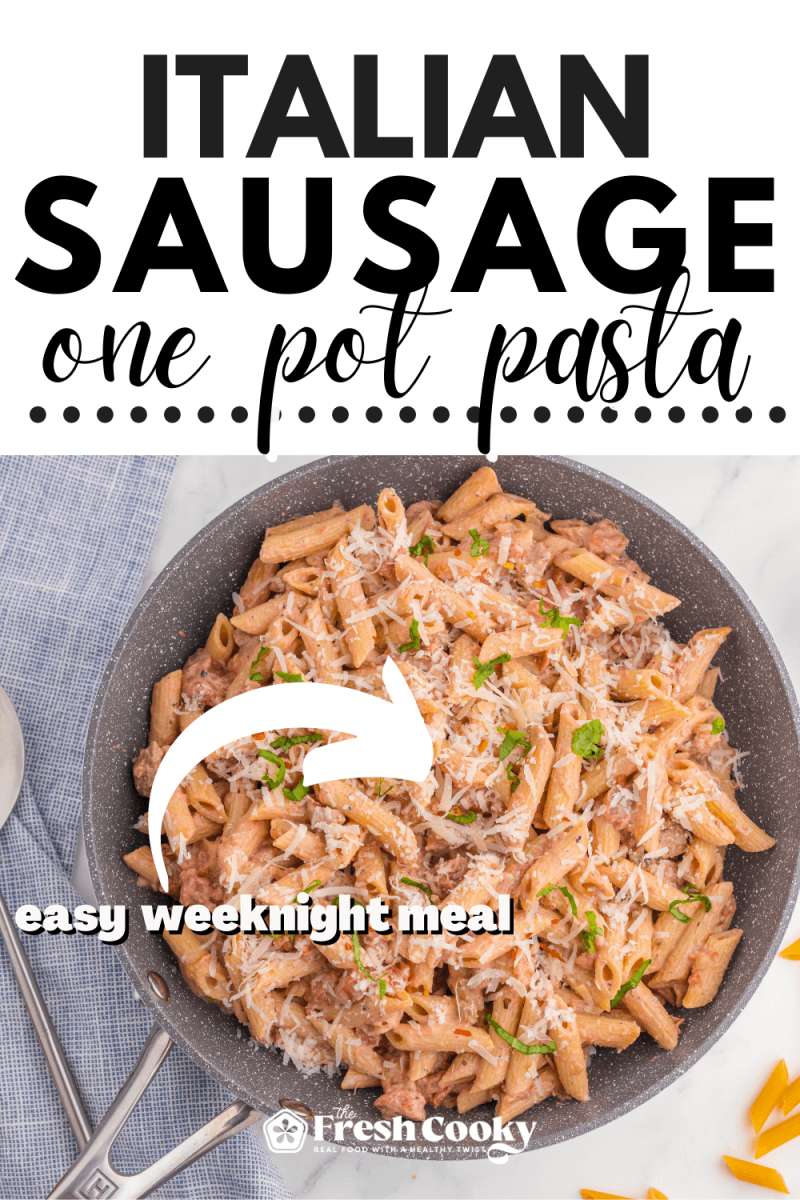 Skillet filled with creamy, one pot Italian sausage and penne pasta in a creamy tomato sauce.