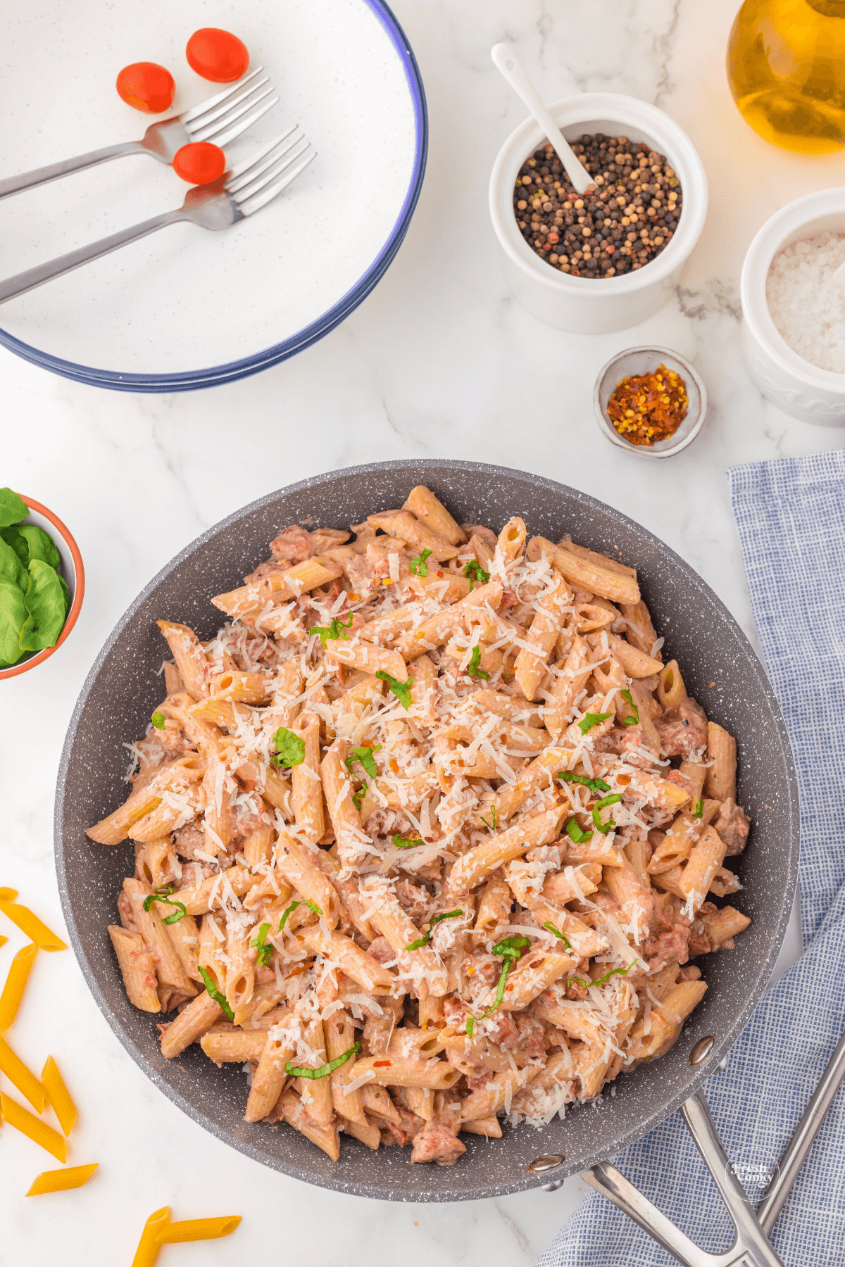 One pot sausage and pasta in skillet with salt and pepper.