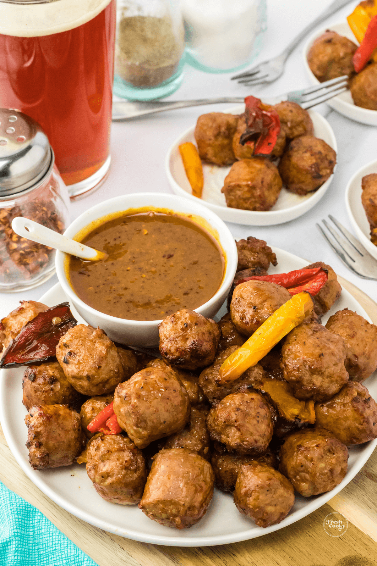 Plate filled with sausage bites and mustard ale dipping sauce.