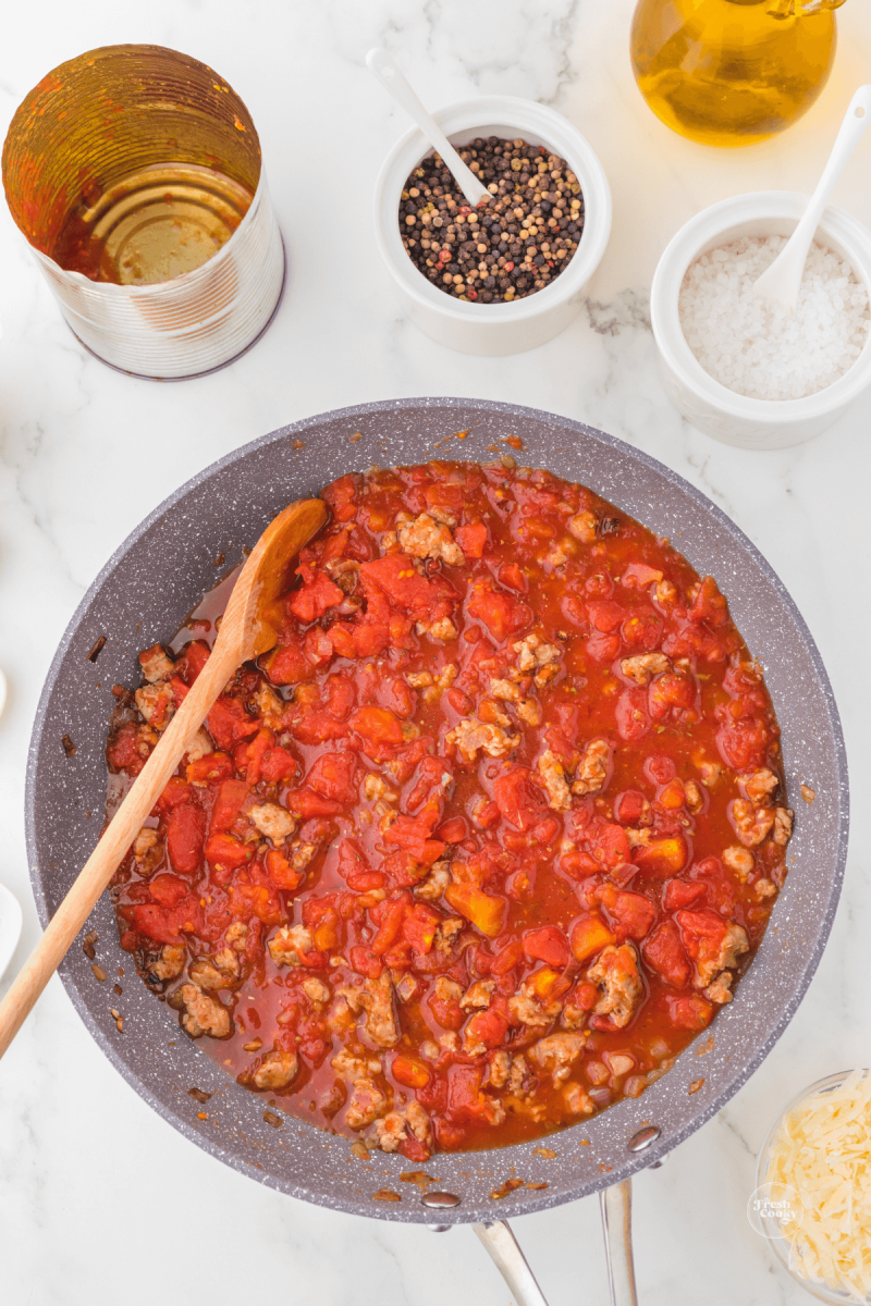 Simmer tomatoes in sausage for about 15  minutes. 