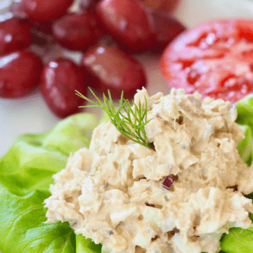 Classic Southern tuna salad on butter lettuce with grapes and tomato slices.