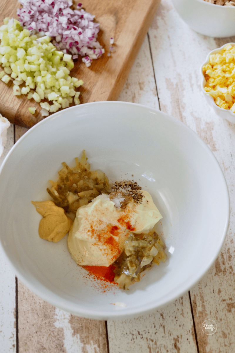 In medium bowl, add ingredients for tuna salad dressing. 