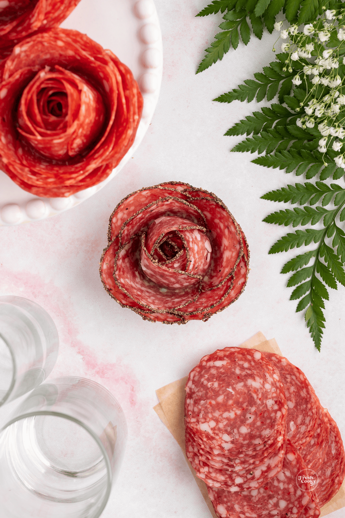 Salami roses on table after removing glass.
