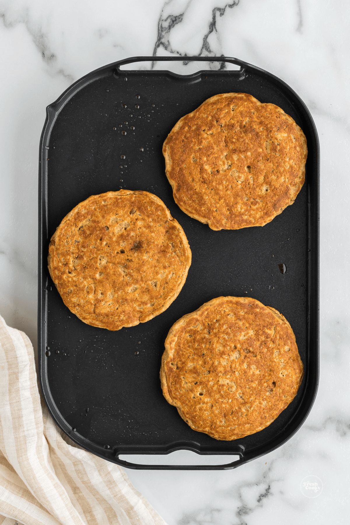 IHOP Harvest pancake recipe golden brown on griddle.