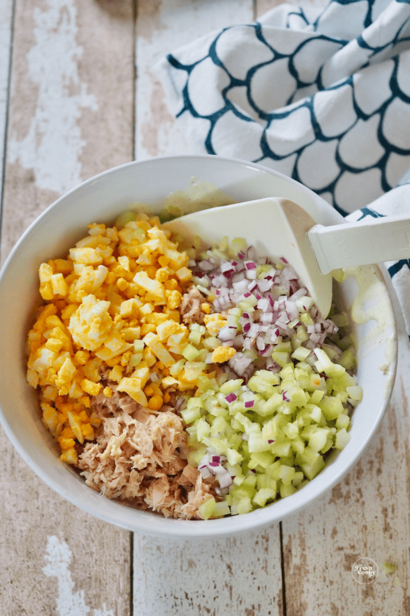 Add tuna, celery, red onion and eggs to dressing, mix well.