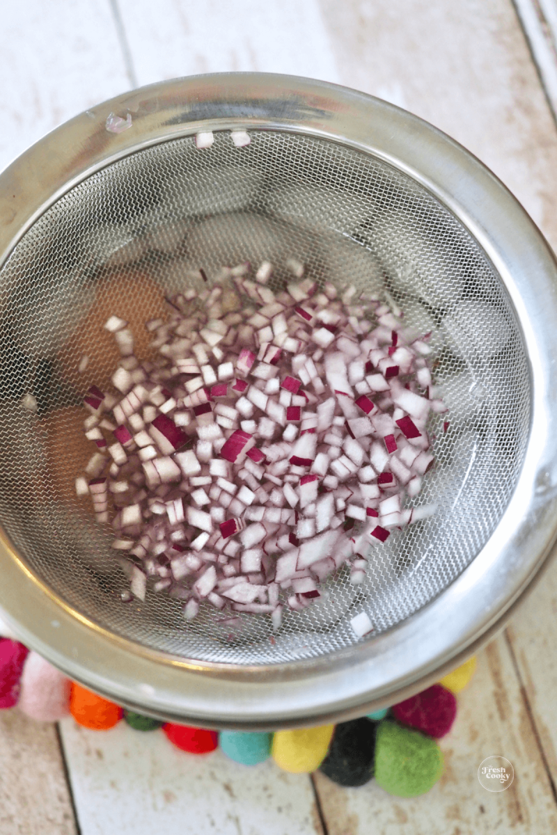 Soak red onion in ice water to remove sharp bite and make milder. 