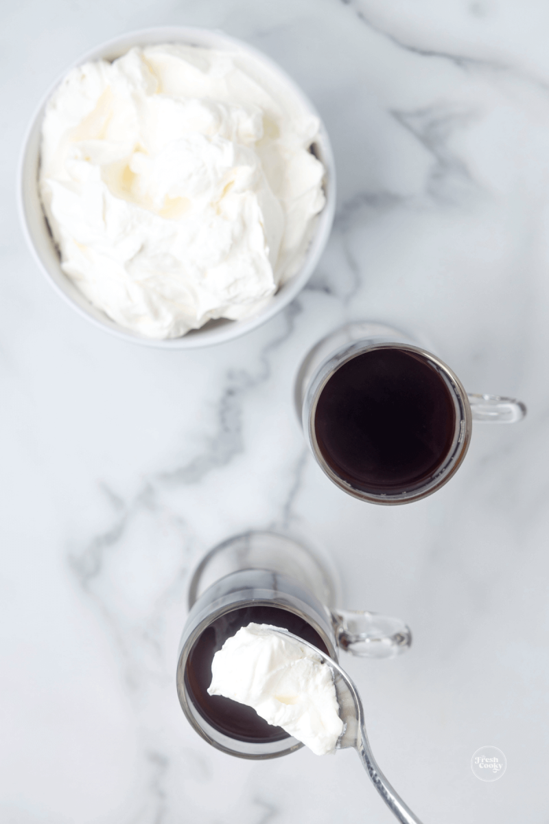 Carefully place whipped cream on top of the Irish coffee. 