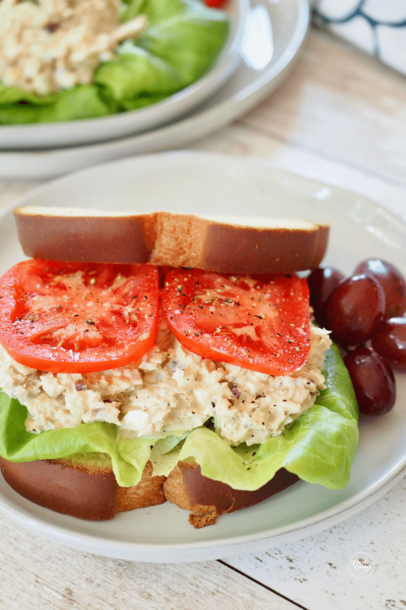 Tuna salad sandwich with lettuce and juicy tomatoes.