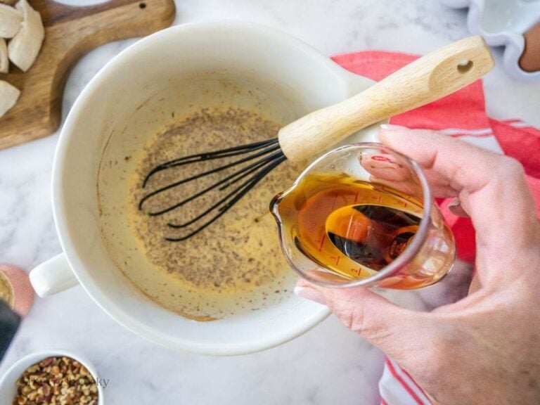 Pouring maple syrup into custard mixture.