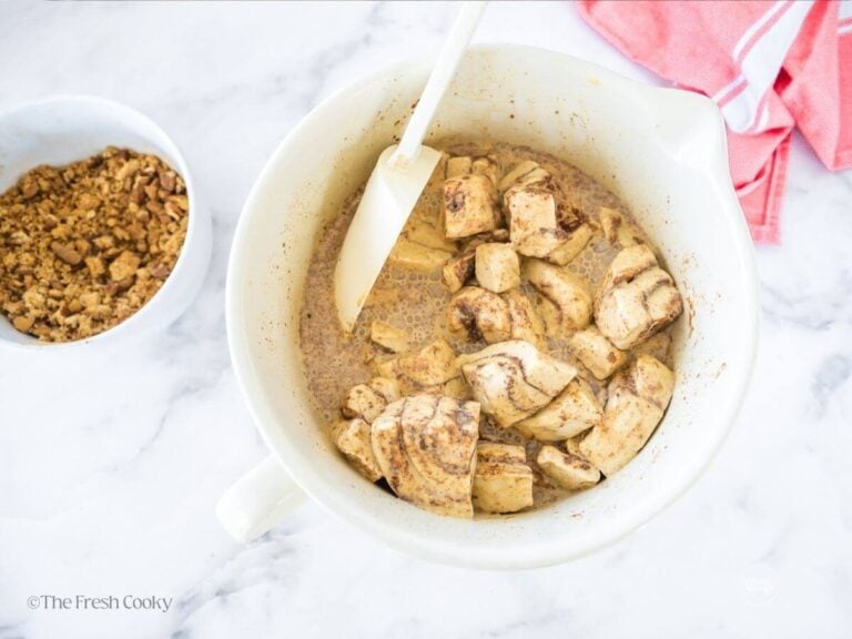 Stirring cinnamon rolls in custard.