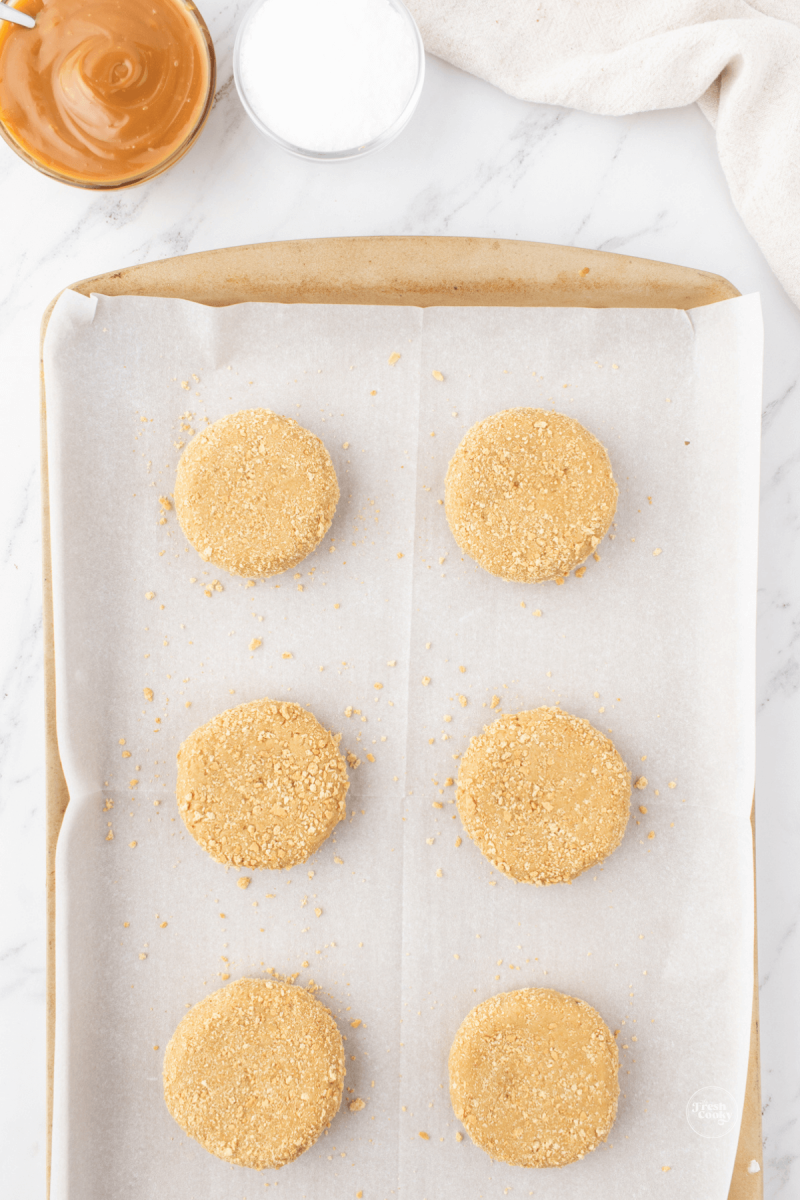 Flatten salted caramel cookie dough balls into hockey puck shapes. 