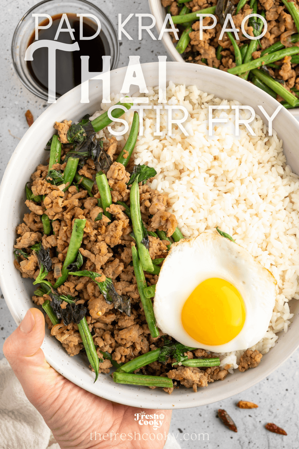 Thai Pork Stir Fry in bowl served with Jasmine rice and a Thai-fried egg, to pin.