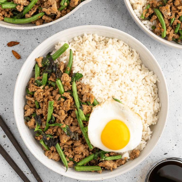 Thai Ground Pork Stir Fry in bowl with Jasmine rice and a Thai fried egg.