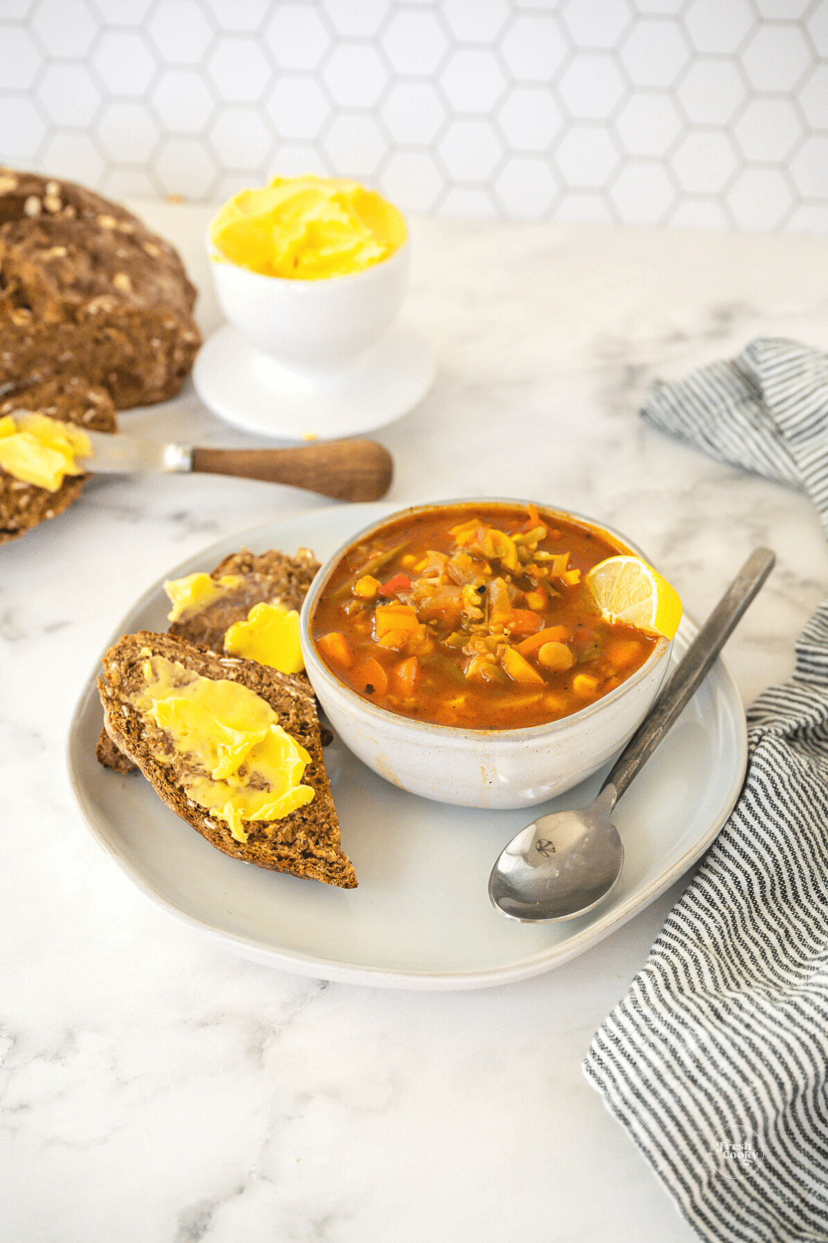 Serving of Irish brown bread with a bowl of hearty vegetable soup.