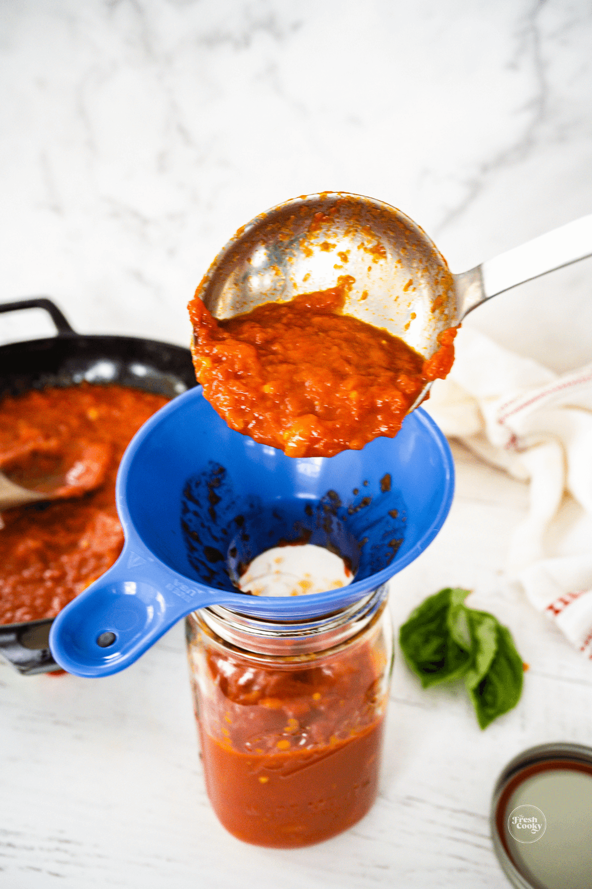 Ladle sauce into jars to store in fridge or freezer.