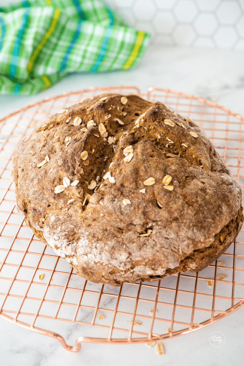 Loaf of Irish brown bread on cooling rack.